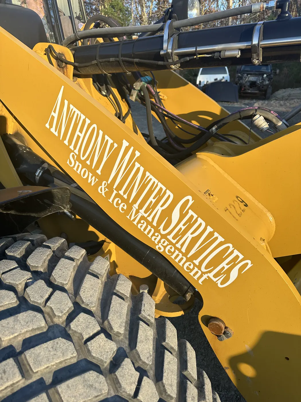 Yellow loader lettered with the Anthony Winter Services name