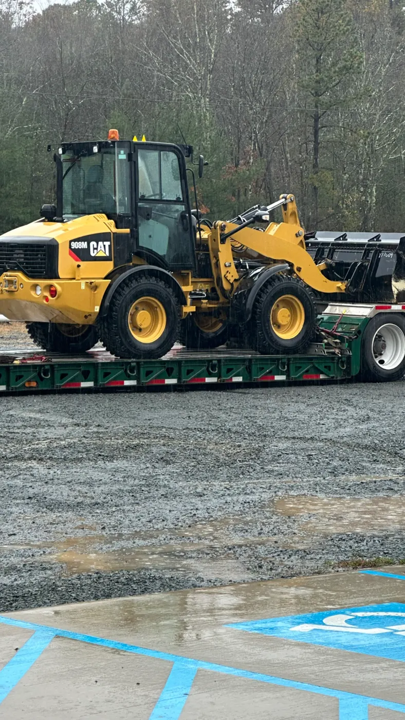 Wheel loader loaded on a trailer for transport to a job site