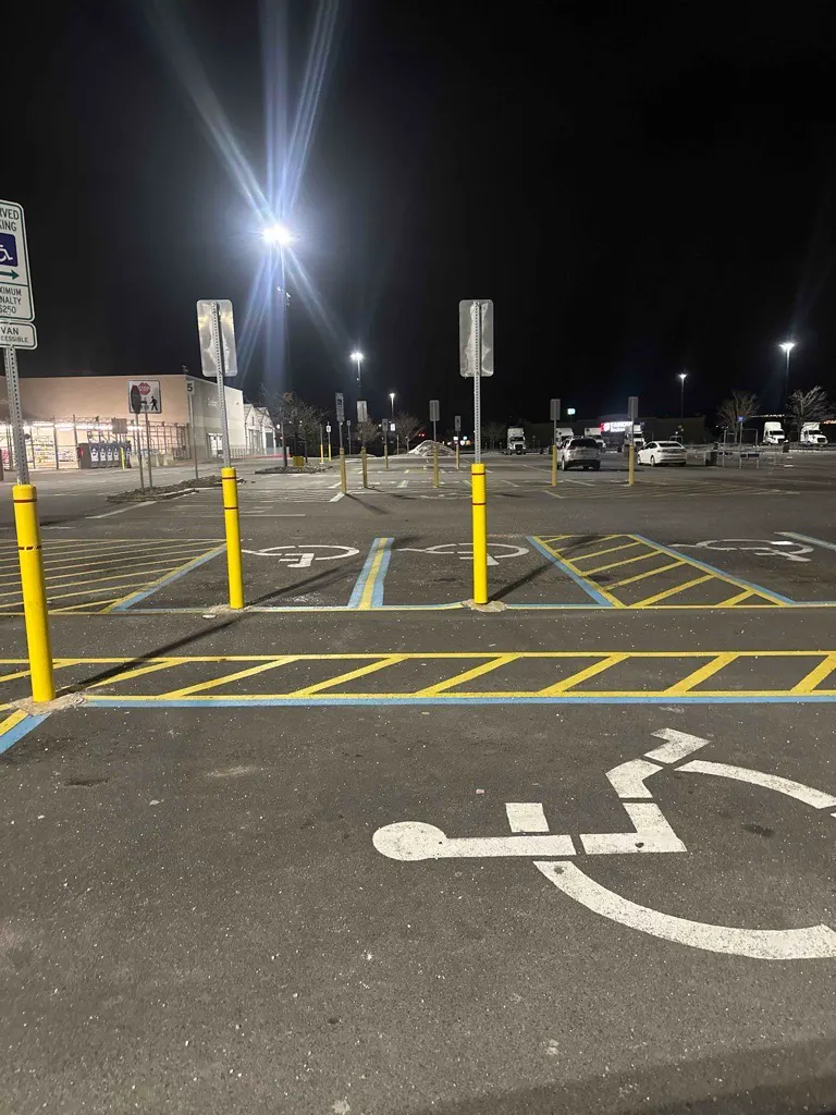 Parking lot cleared down to the painted lines and accessible spaces at night